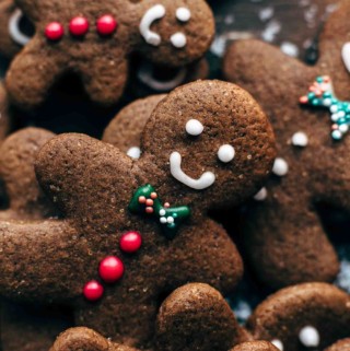 Decorated gingerbread men cookies arranged layered on top of each other