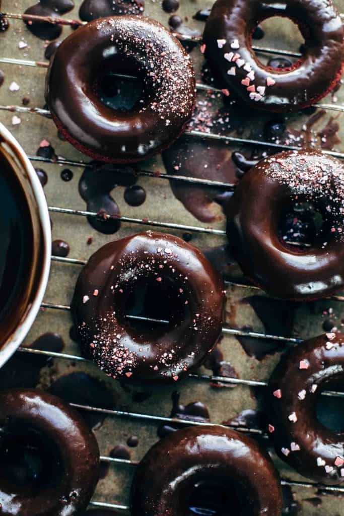 Chocolate glazed donuts on a baking rack