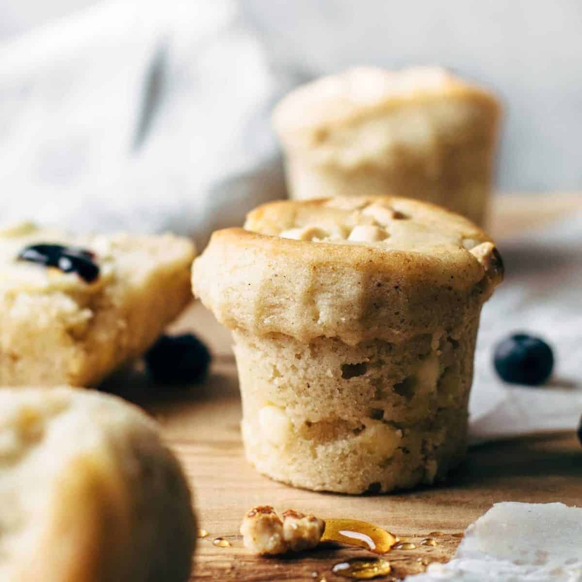 Baked muffins with white chocolate chips on a wooden table
