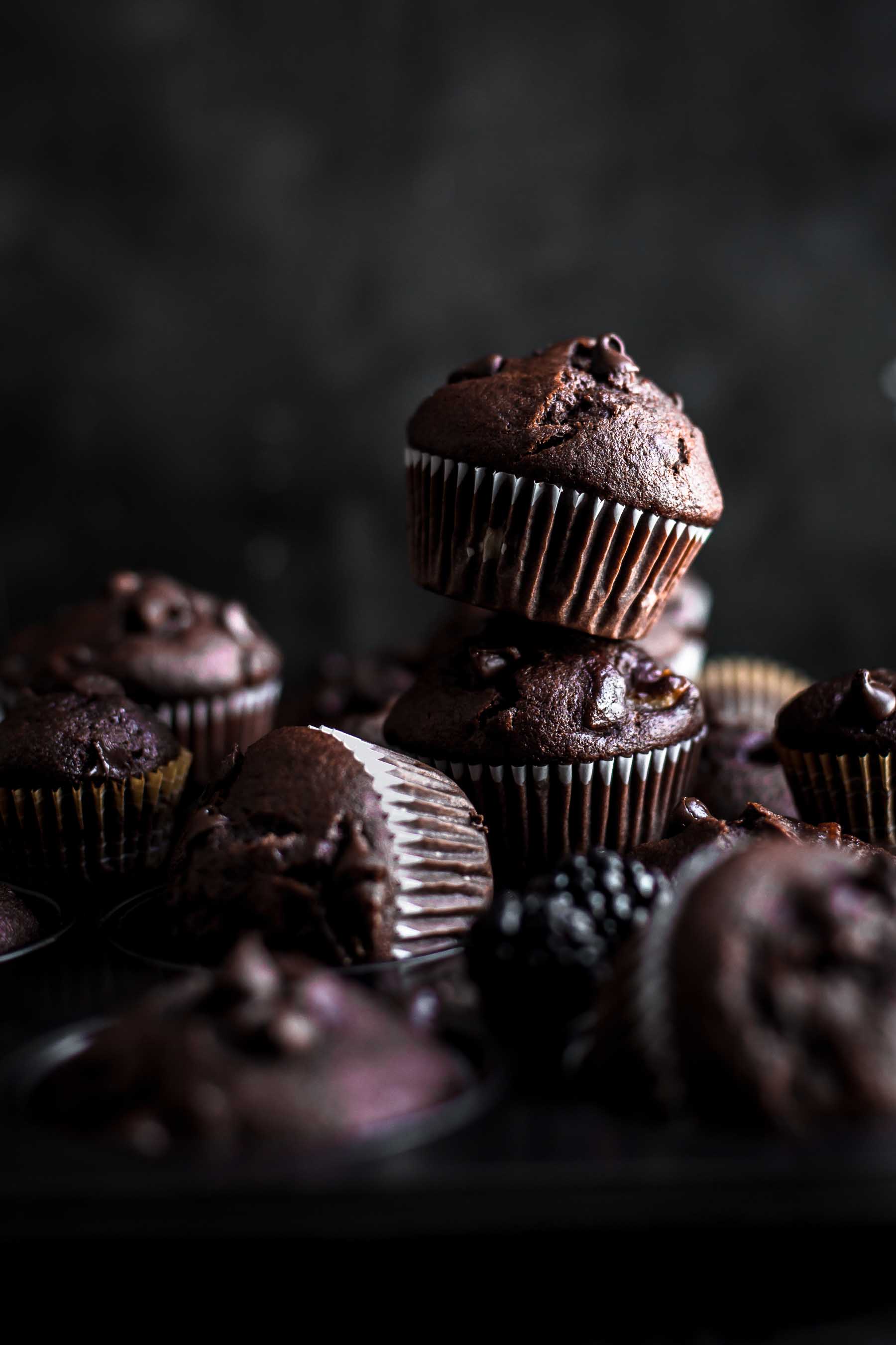 a half dozen muffins on a dark background