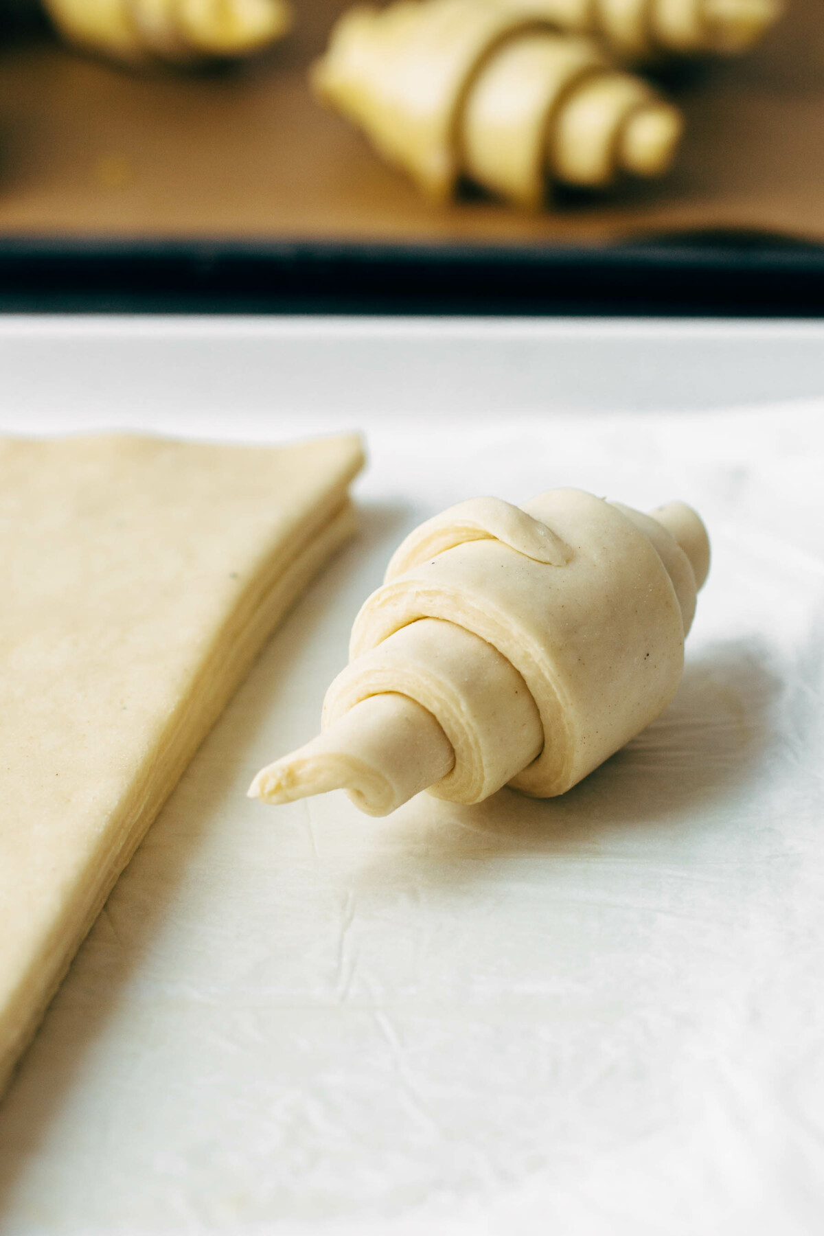 rolled croissant roll on baking sheet 