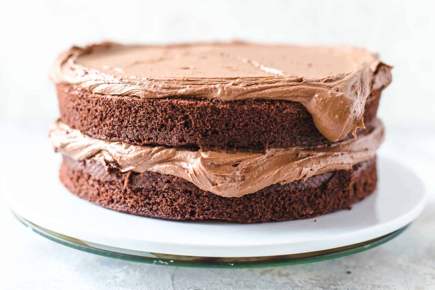 two chocolate cake layers filled with chocolate frosting