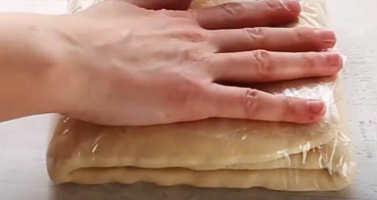 folded croissant dough covered in cling wrap