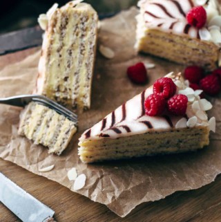 Slices of Esterhazy torte on a cutting board with a long knife