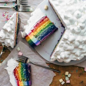 Sliced rainbow cake on a cake plate