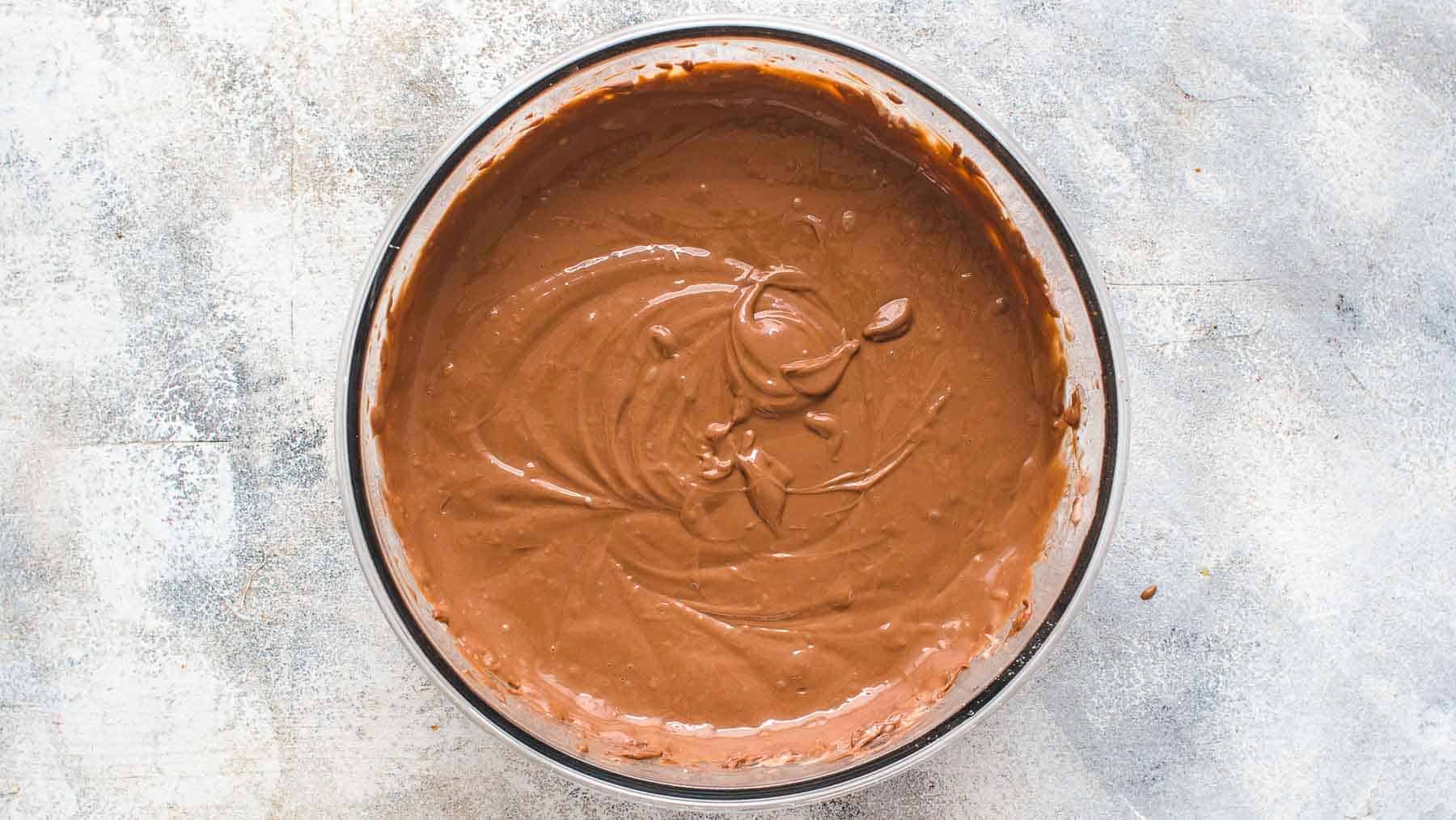 mixed chocolate cream cheese batter in a glass bowl