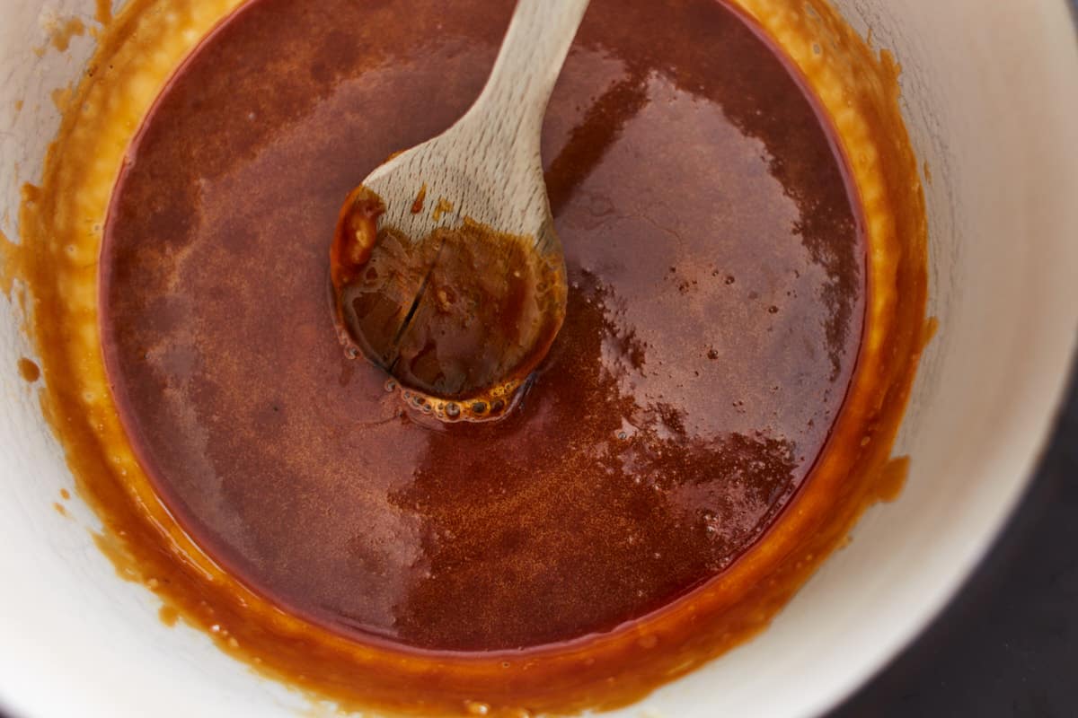 liquefied caramelized sugar in a pot with a wooden spoon