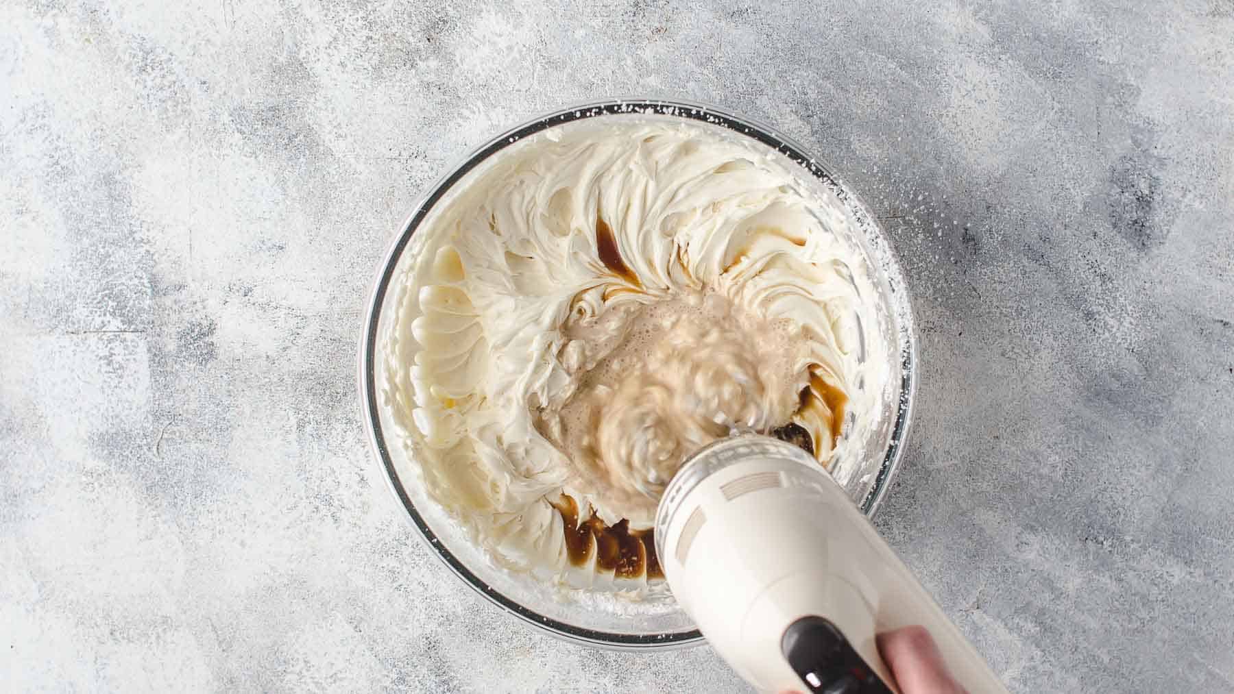 mixing coffee into mascarpone frosting