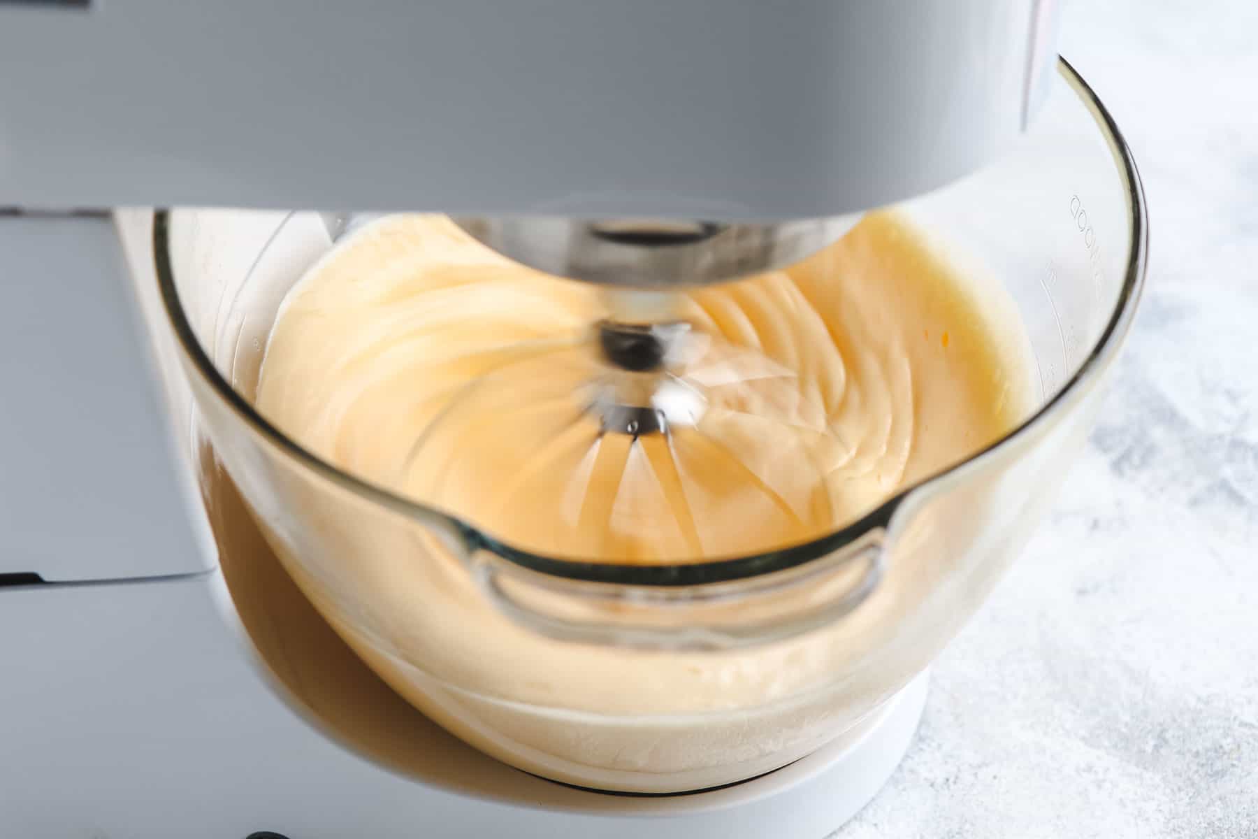 pale egg mixture being mixed in stand mixer