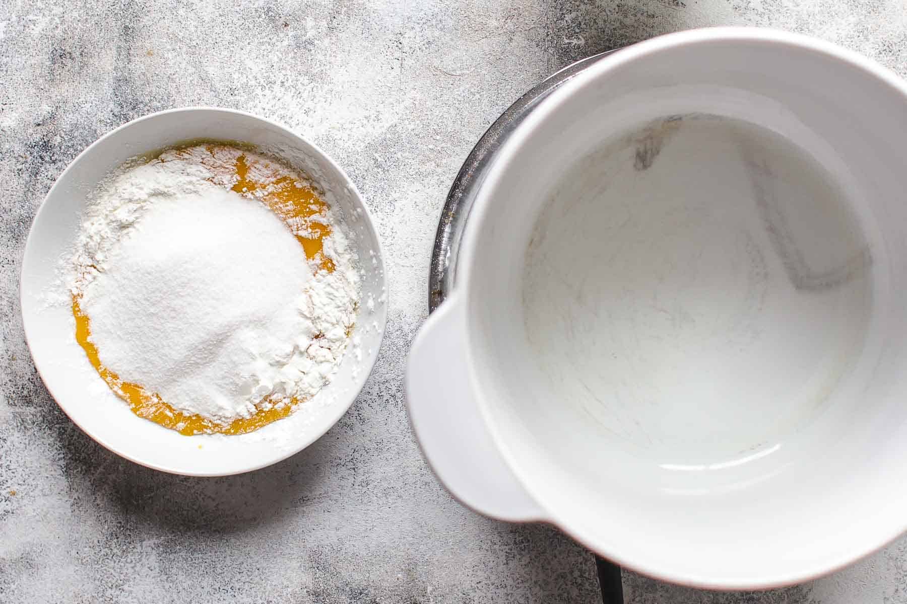 yolks, sugar, and cornstarch in a bowl sitting next to a pot