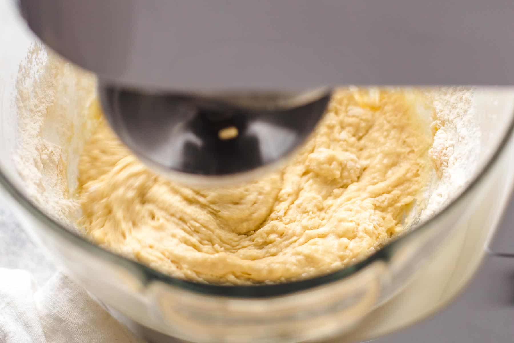 mixing soft and wet yeast dough in a bowl