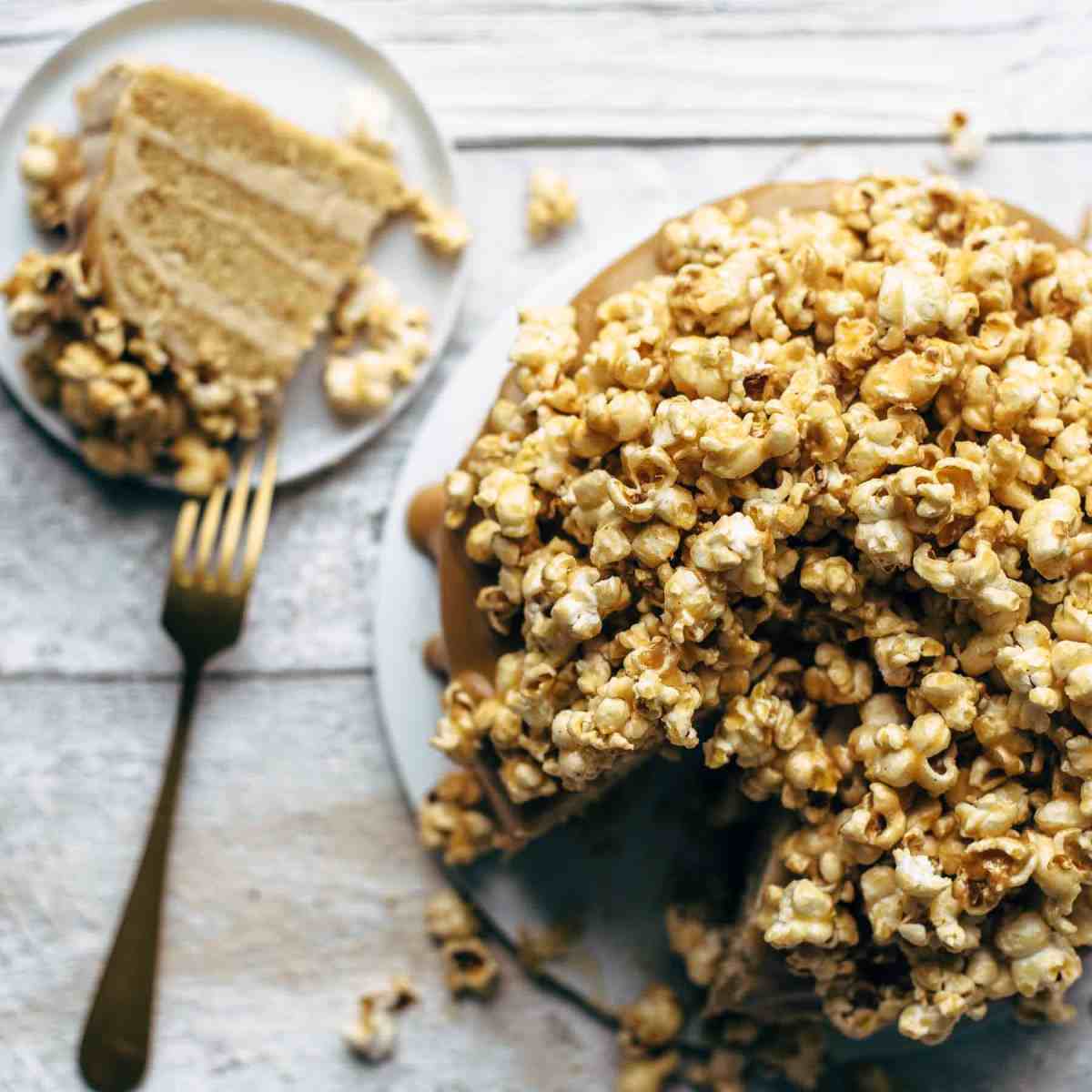 Top view shot of a cake topped with loads of caramel coated popcorn