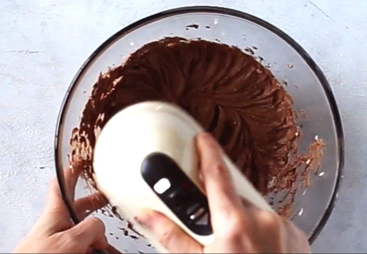 mixing chocolate buttercream frosting