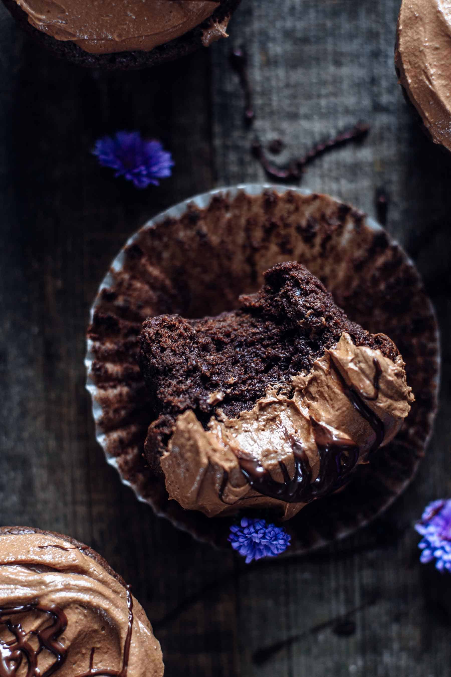 half eaten chocolate cupcake on a dark table