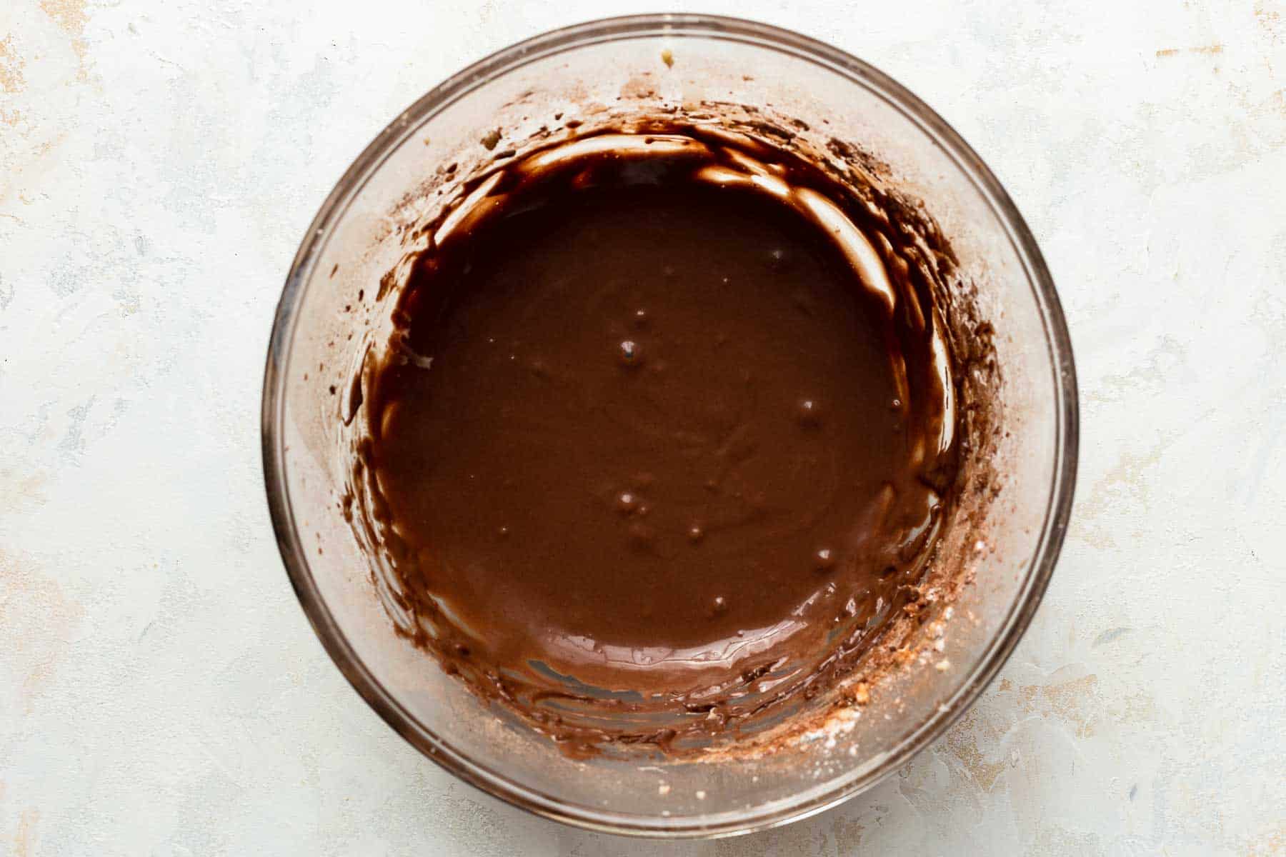 chocolate icing in a glass bowl