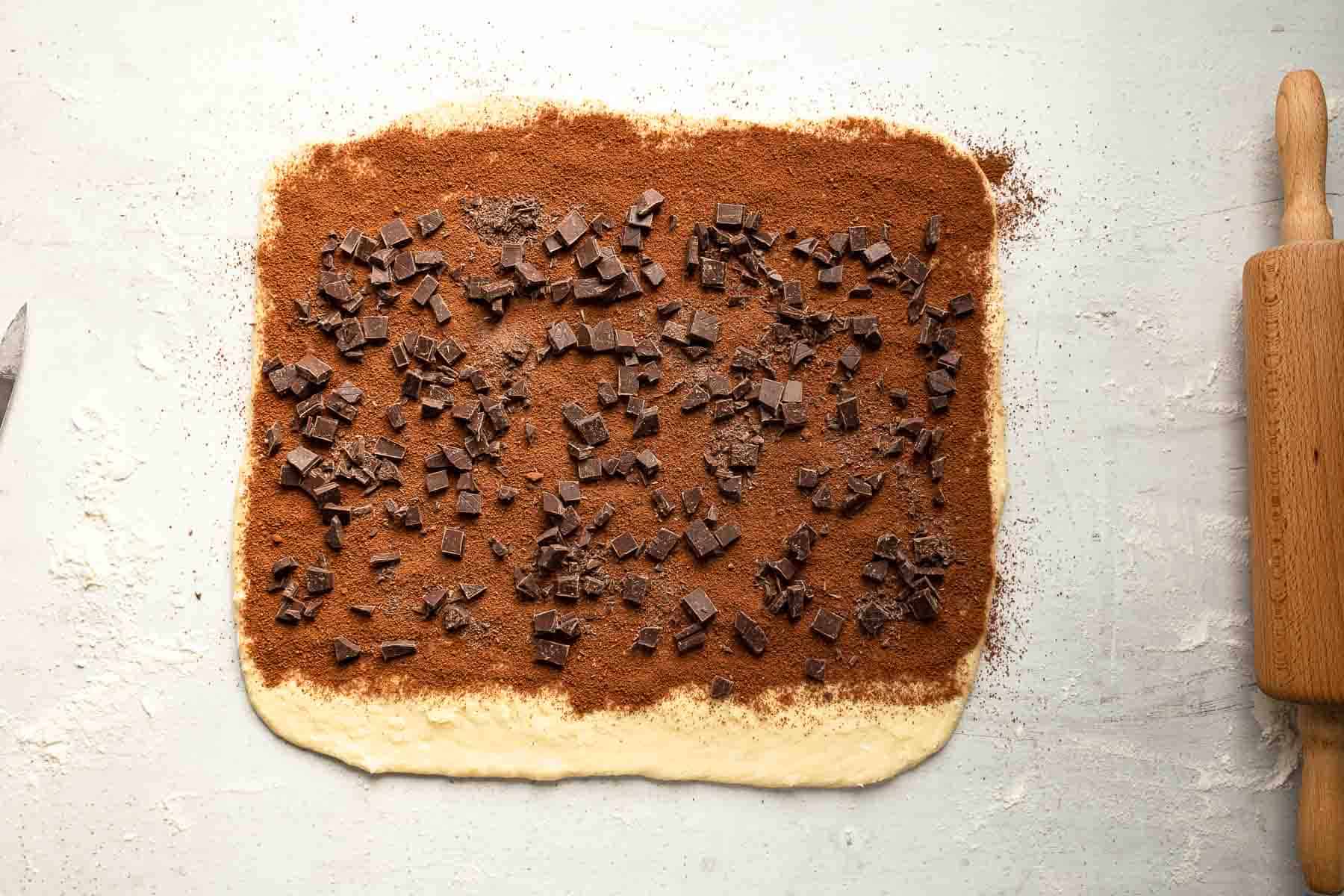 dough with chocolate and cinnamon sprinkled on it