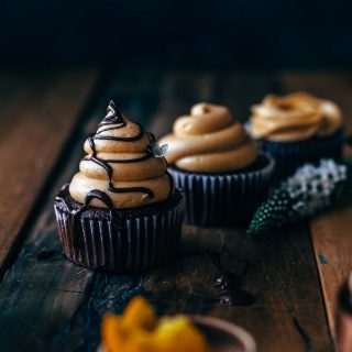 Chocolate cupcakes with chocolate decoration on a wooden board