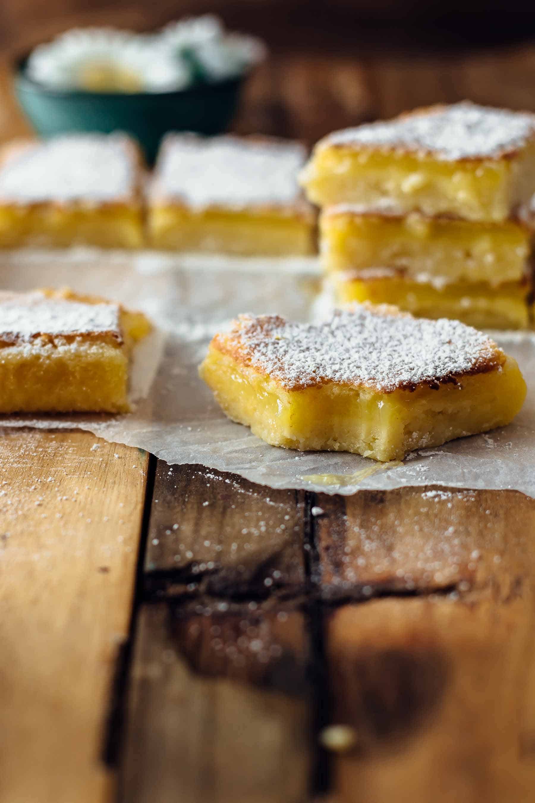 Decorative picture of bitten lemon bars on a wooden table