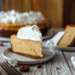 A slice of sweet potato cheesecake on a dessert plate topped with meringue