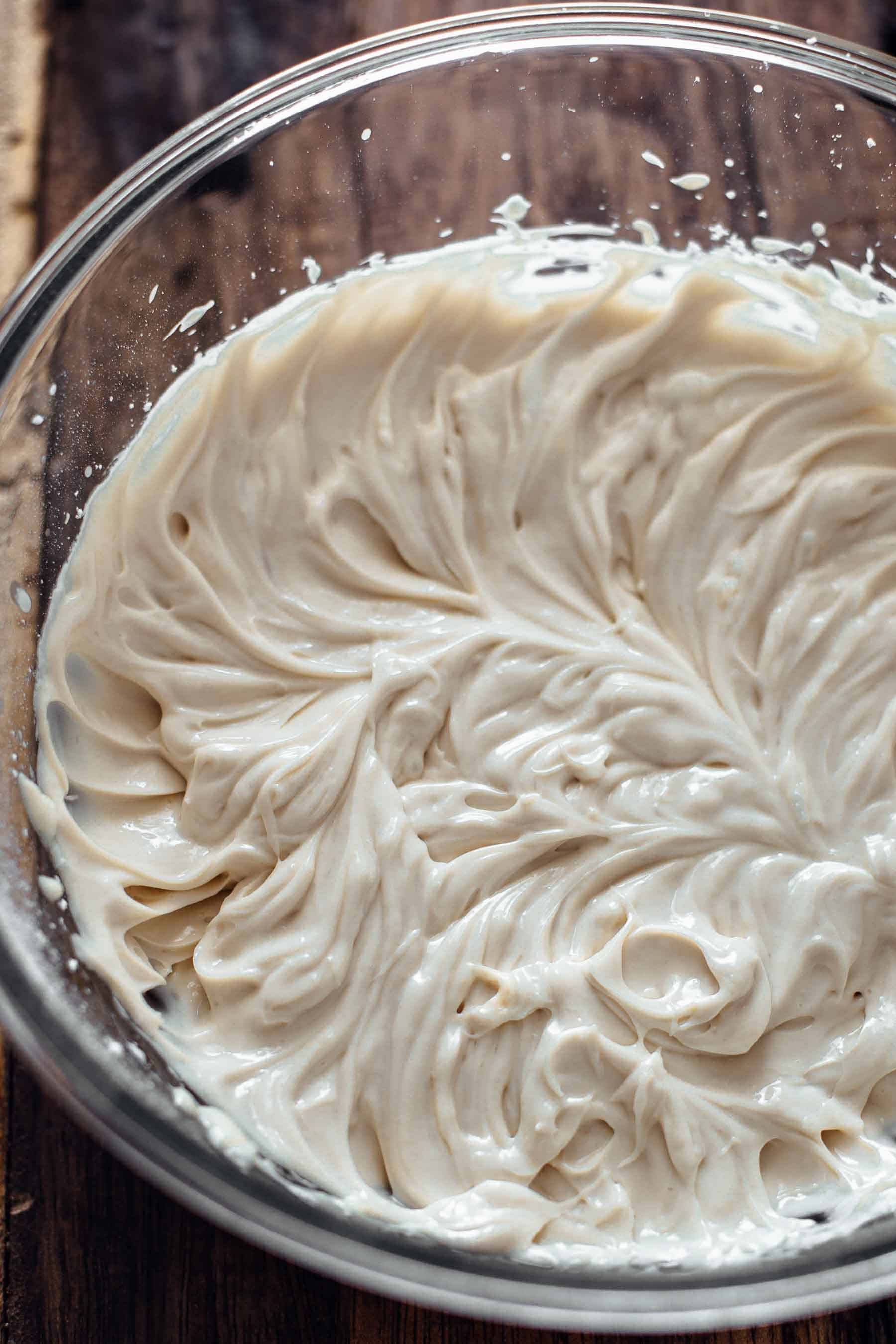 mixed mascarpone frosting in a glass bowl
