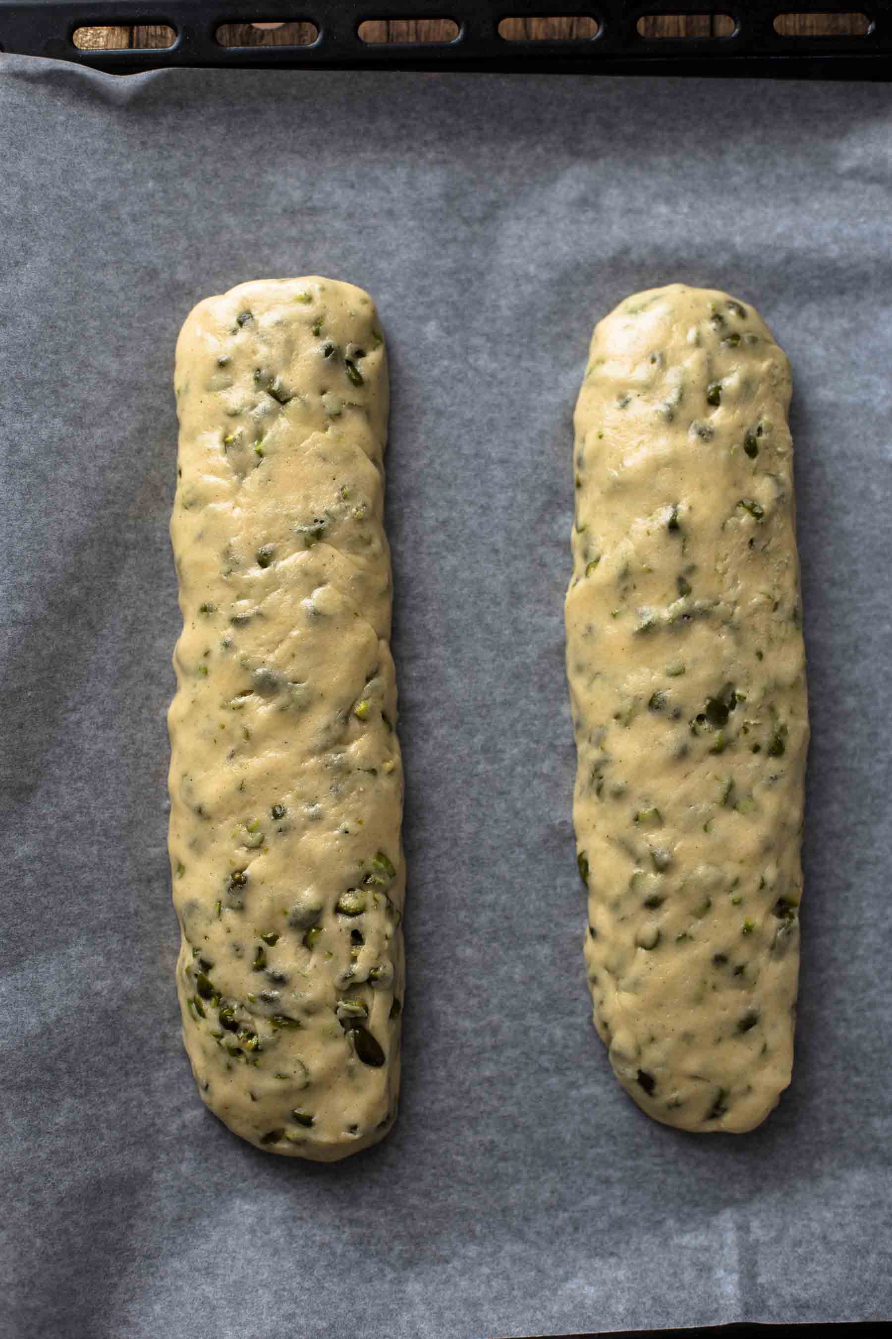 two logs of shaped cookie dough on a baking sheet