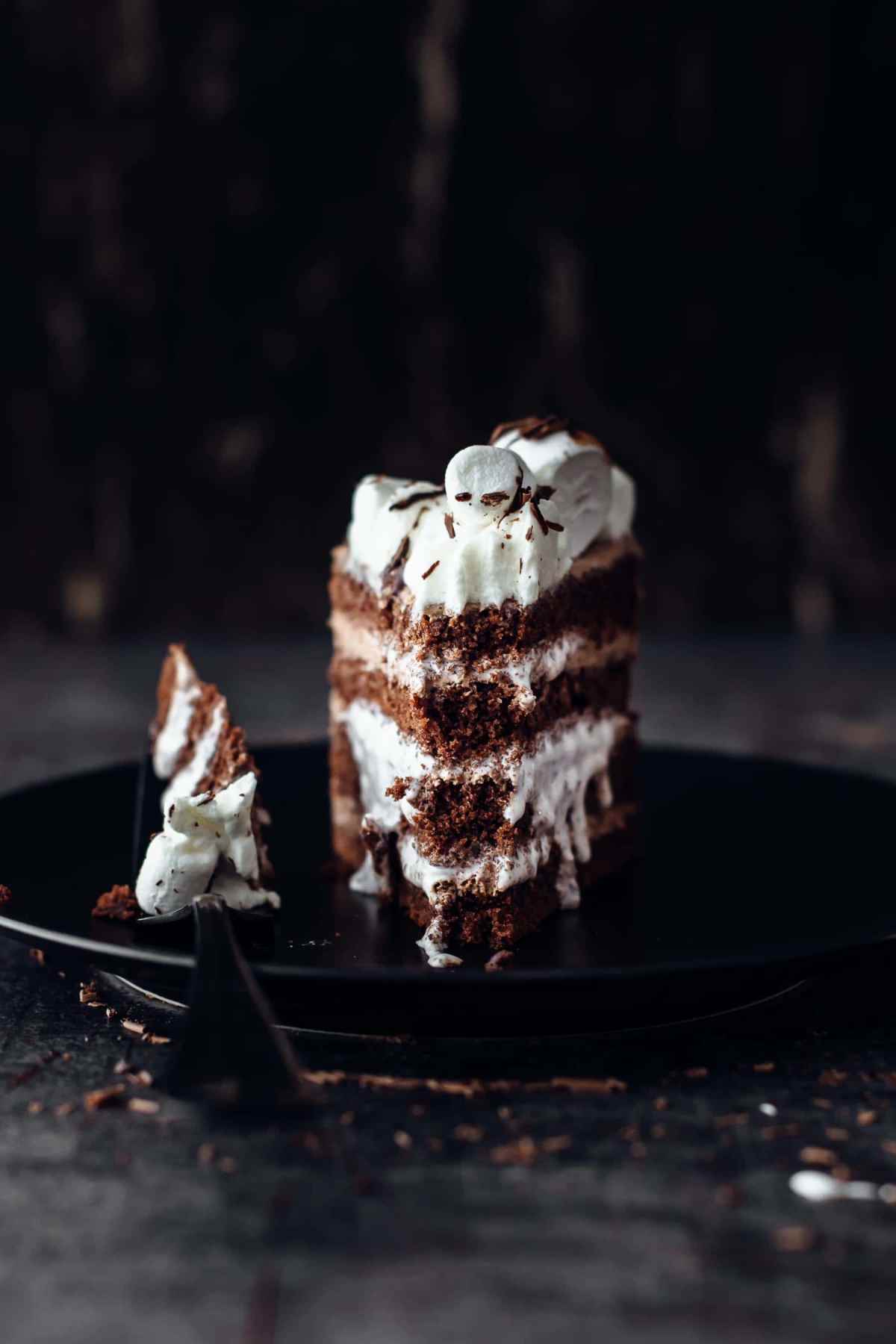 sliced chocolate layer cake filled with oozing marshmallow fluff and topped with marshmallow