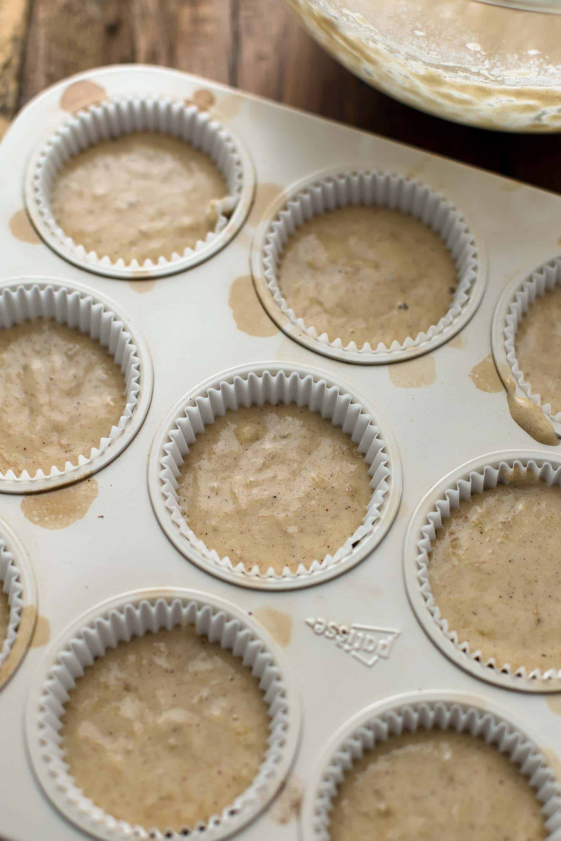 muffin pan lined with cupcake liners filled with cupcake batter