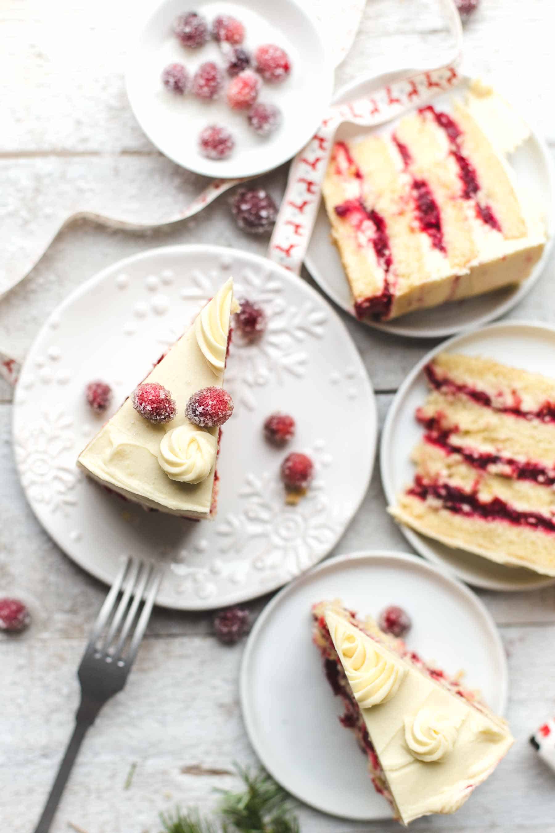 Slice of Cranberry Orange Cake with White Chocolate Frosting on a plate