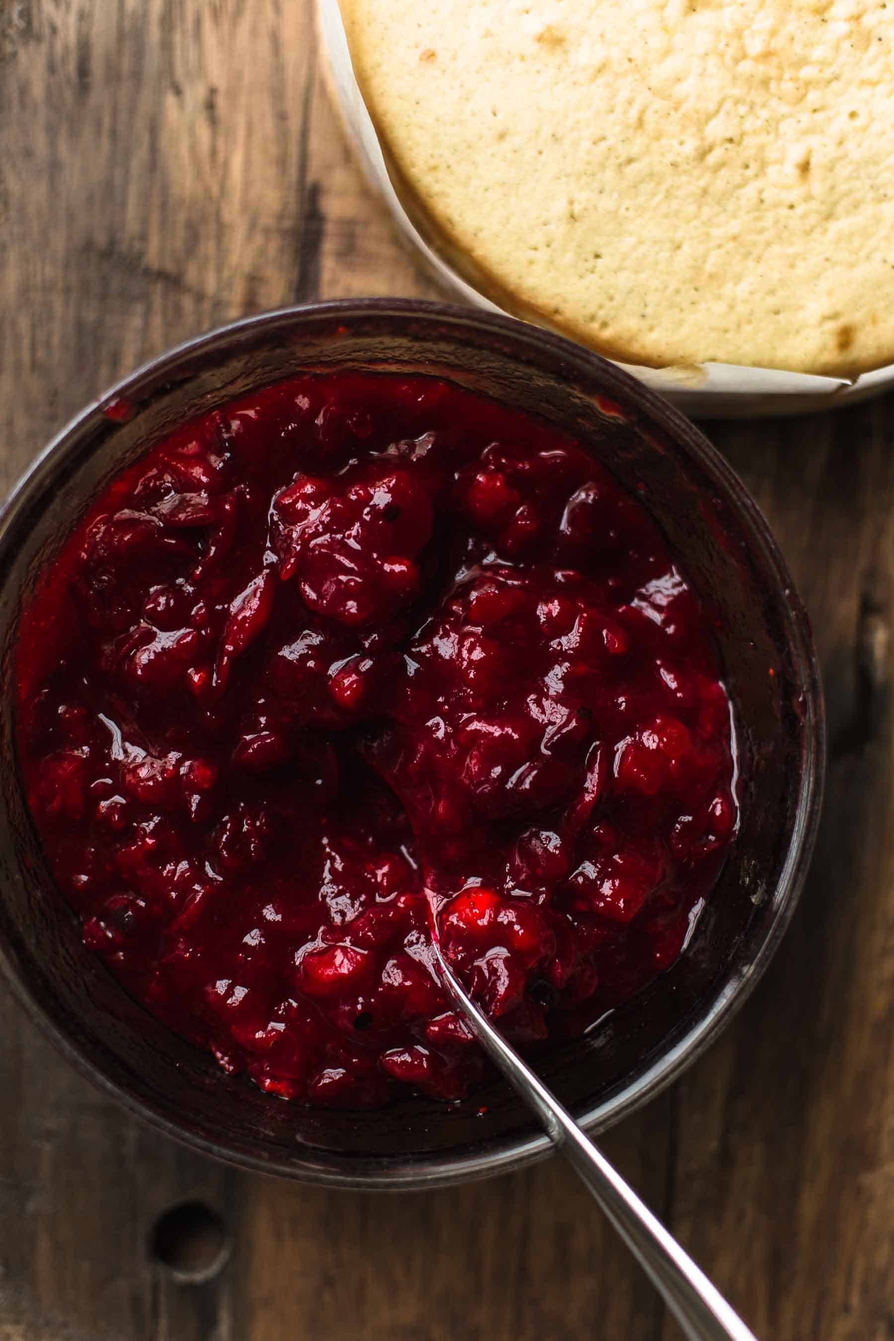 cooked cranberry filling in a bowl with a spoon