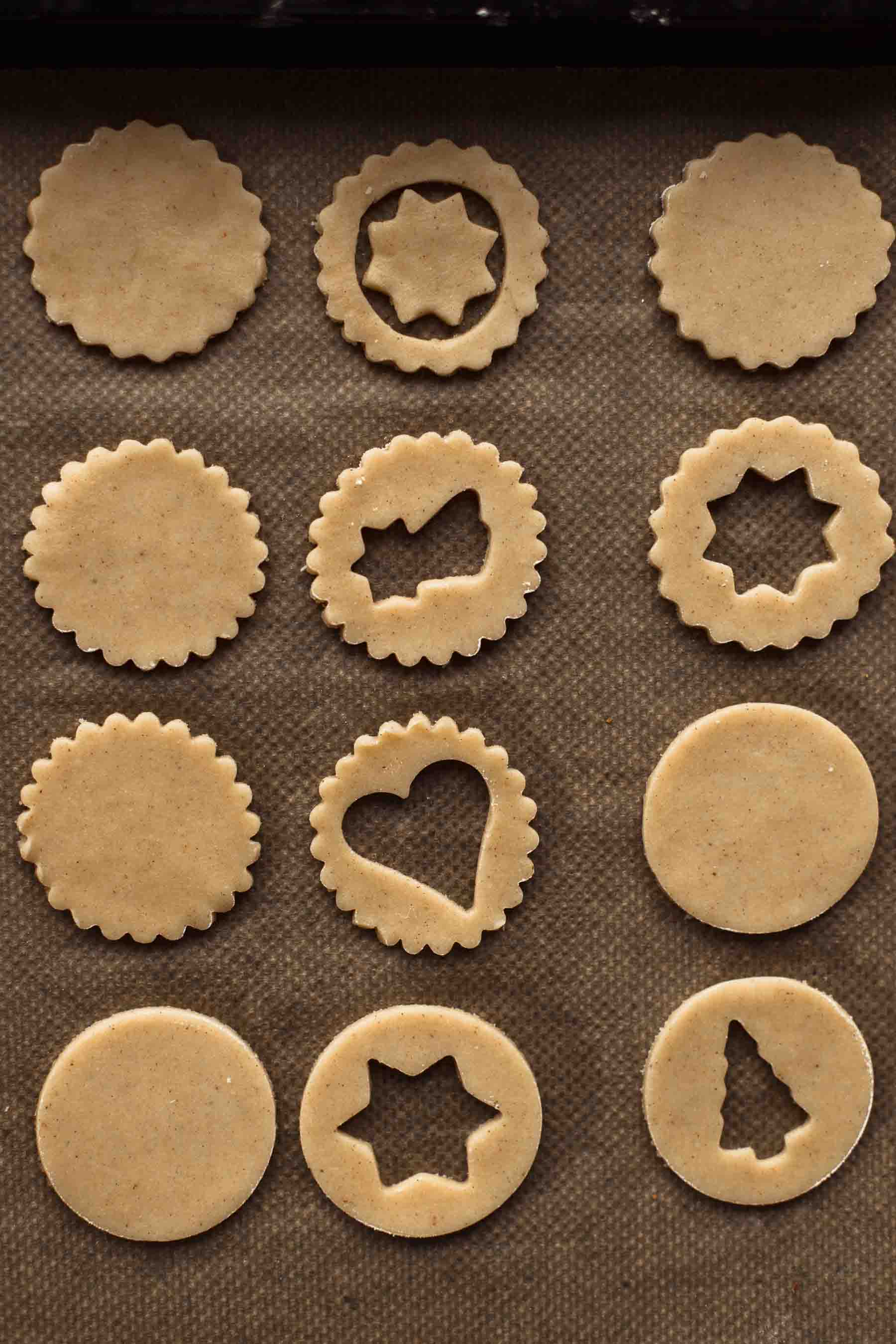 Unbaked cut Linzer Cookies on a baking sheet