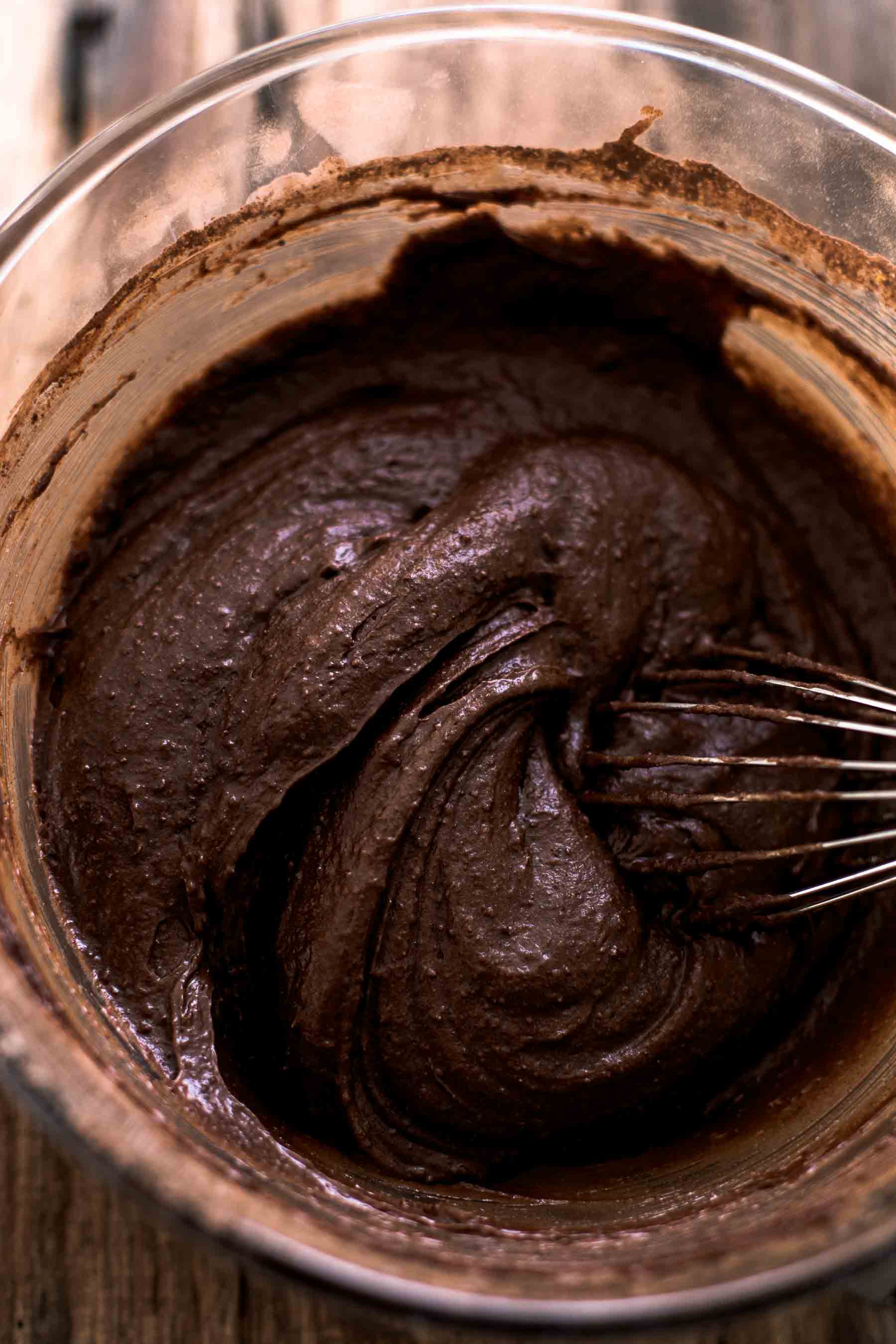 mixed brownie batter in a bowl with a whisk