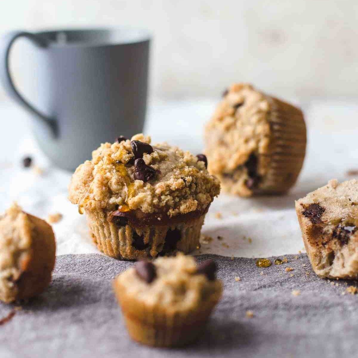 regular and mini sized muffins on a two colored napkin with a blue colored cup
