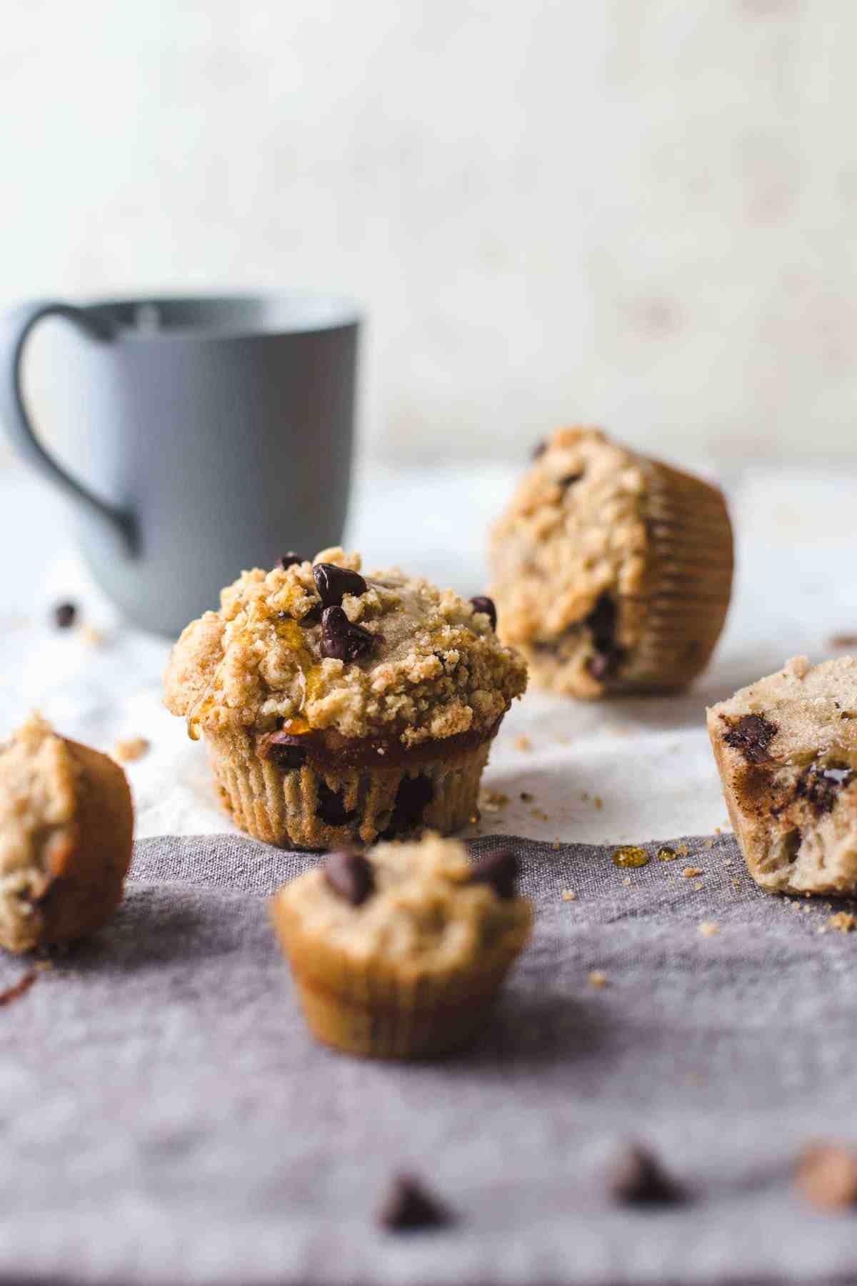 regular and mini sized muffins on a two colored napkin with a blue colored cup