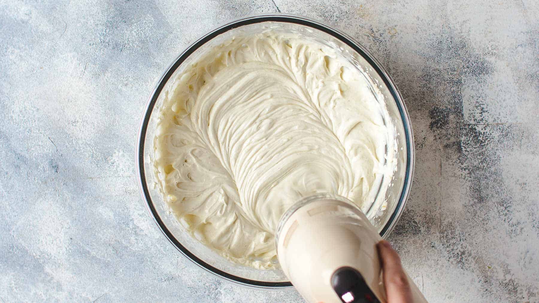 smooth cream cheese mixture in a bowl with a mixer