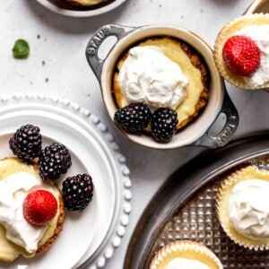 half dozen baked mini cheesecakes in ramekins and on serving plates