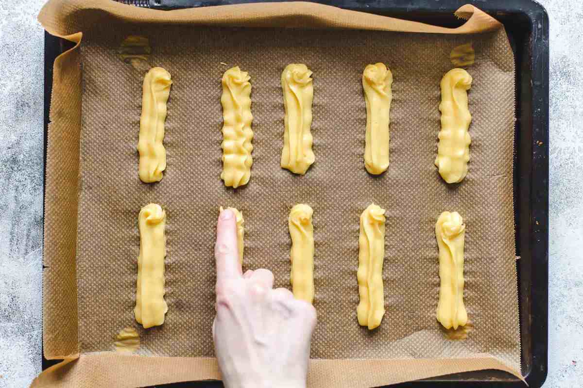 pressing down the tip of the puff pastry with wet finger