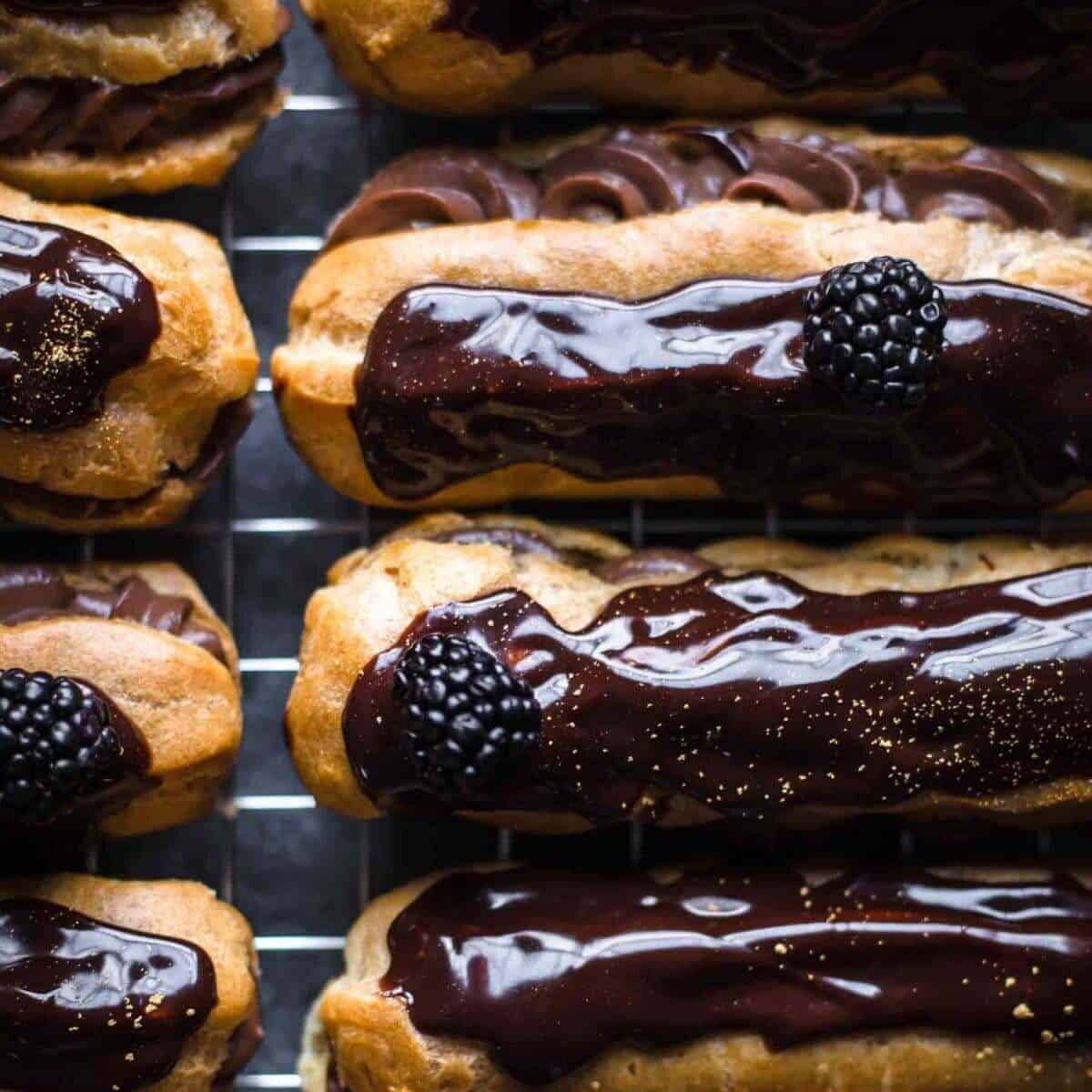 close up of a dozen chocolate eclairs