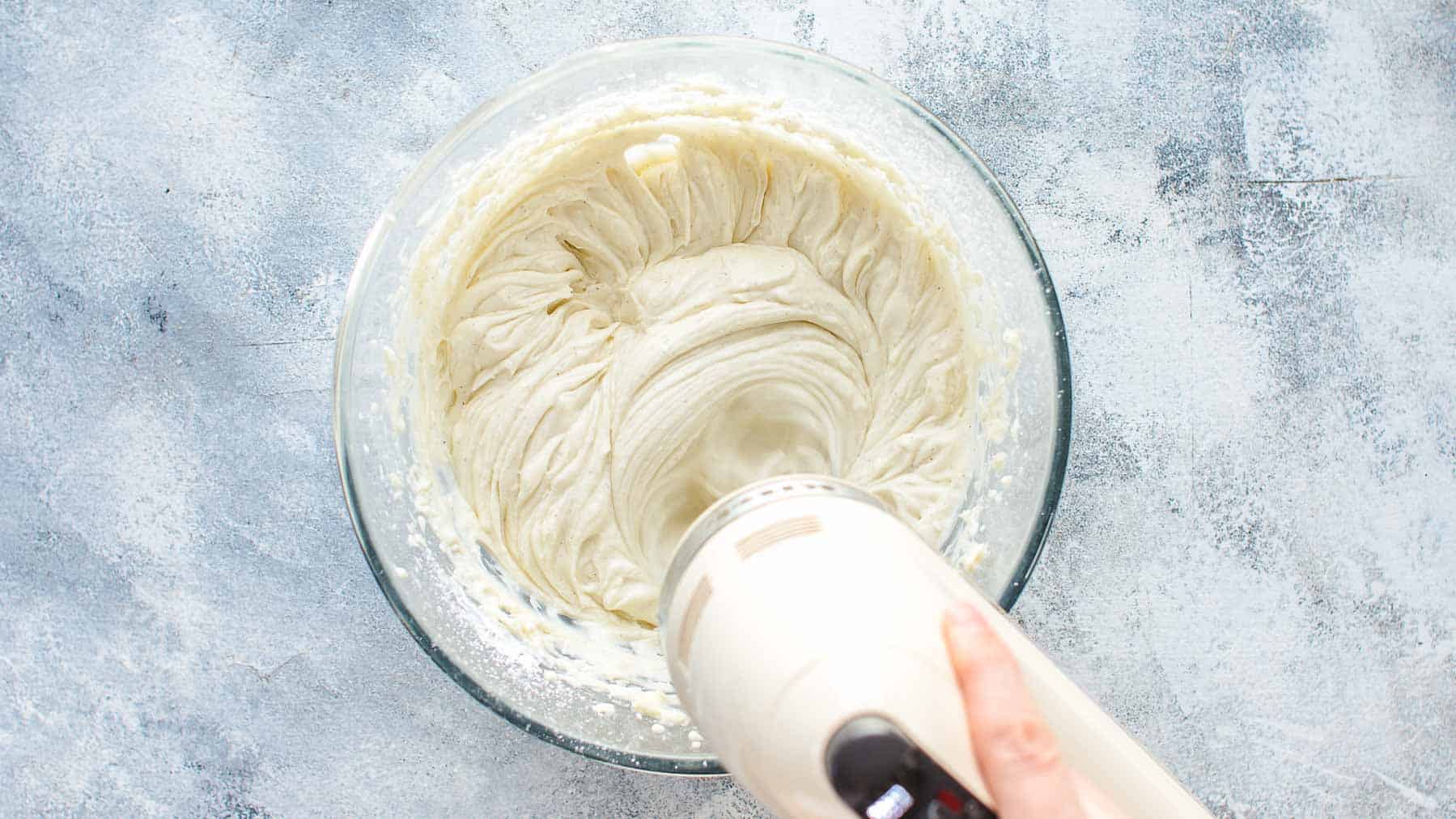 Mixing coconut frosting in large mixing bowl