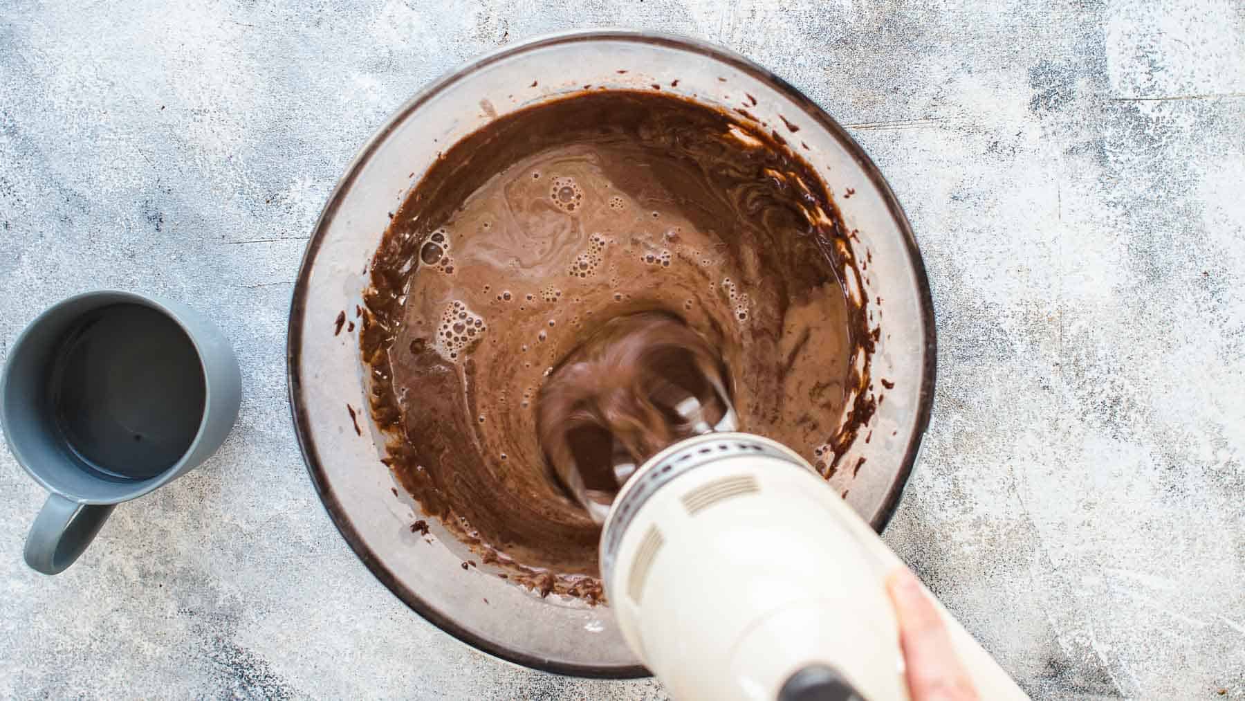 Adding hot water to the chocolate cake batter
