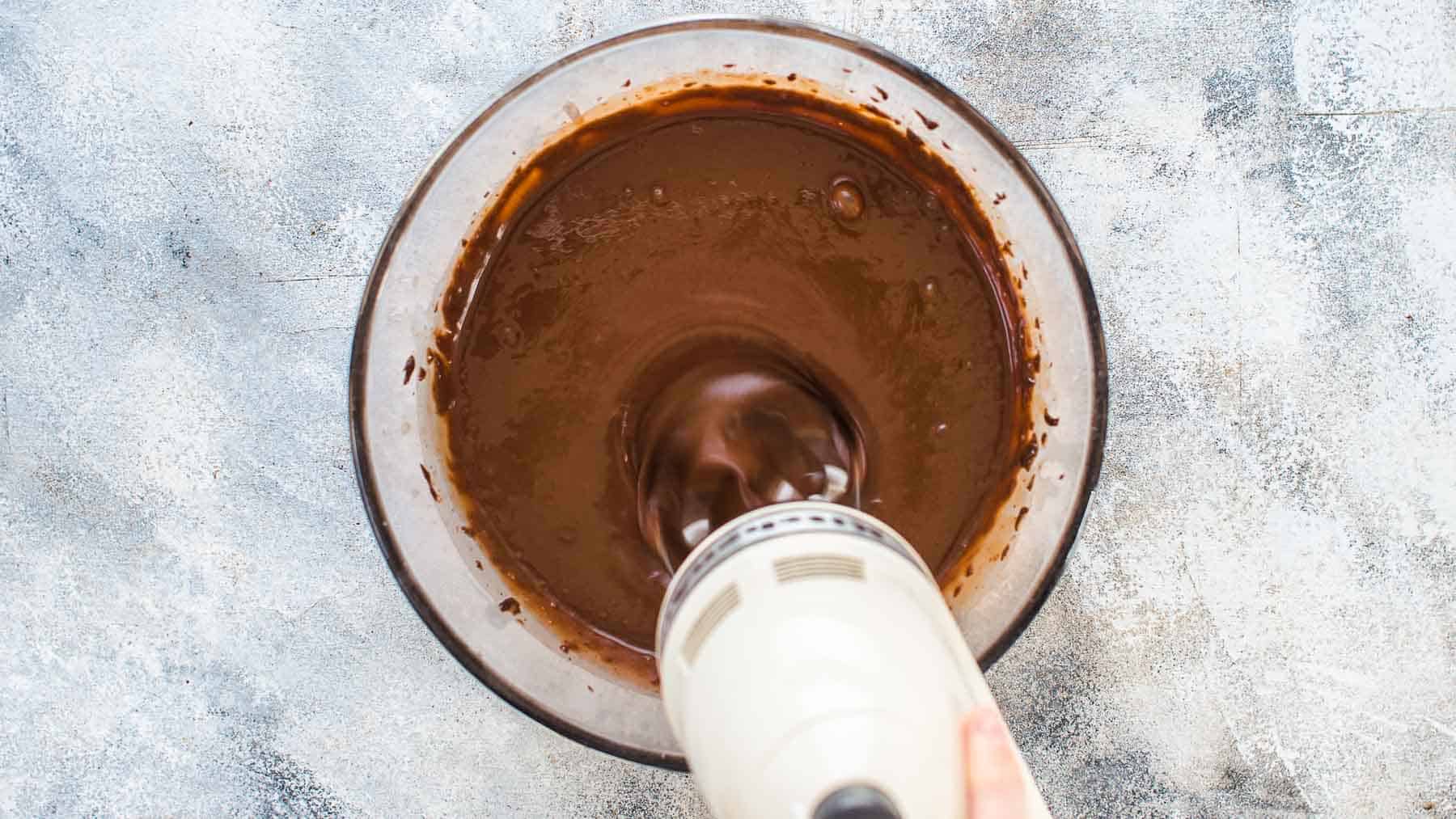 Mixing chocolate cake ingredients in a large mixing bowl