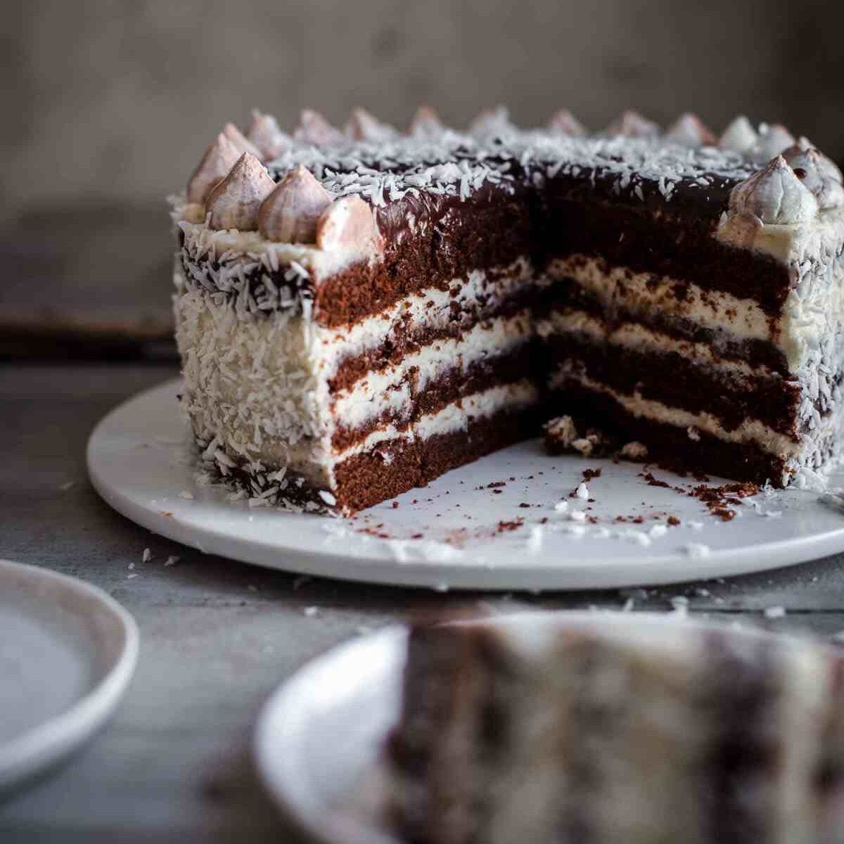 Cut chocolate coconut cake on a serving plate