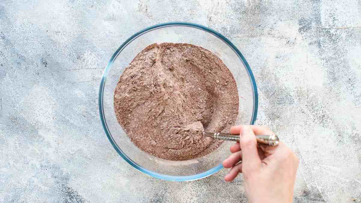 Combining all dry ingredients for the chocolate cake in a large mixing bowl