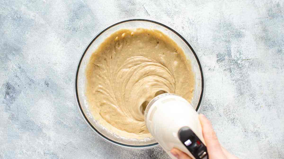 Mixing all banana cake ingredients in a large mixing bowl