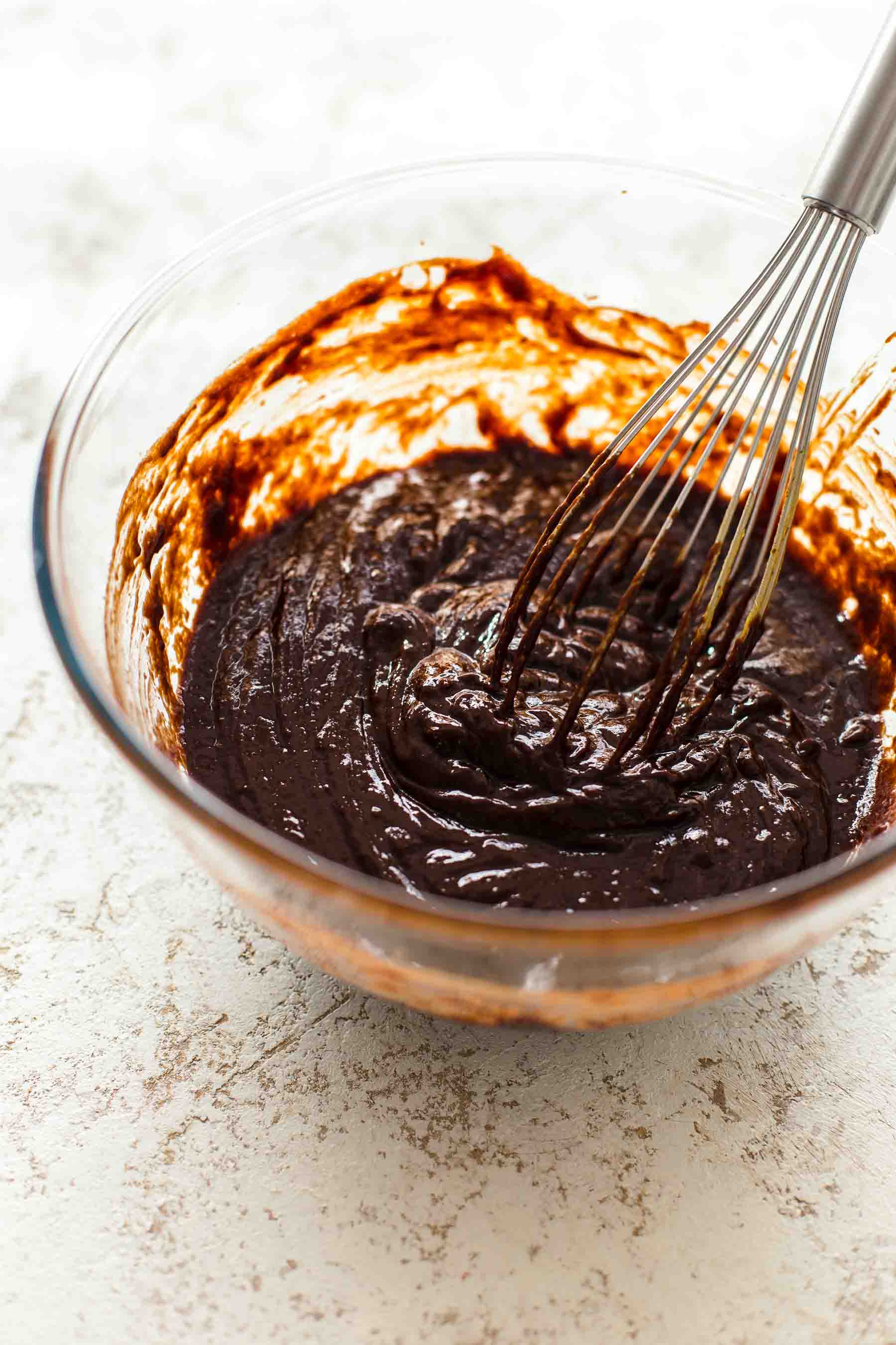 mixed chocolate ganache in a bowl with a whisk