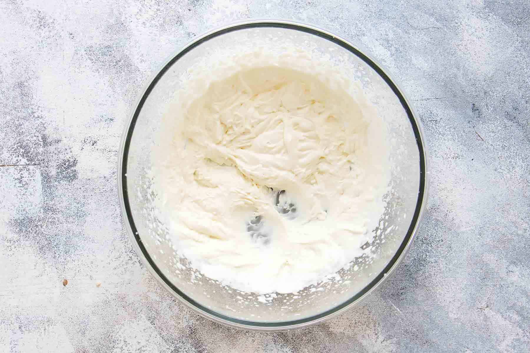 soft whipped cream in mixing bowl