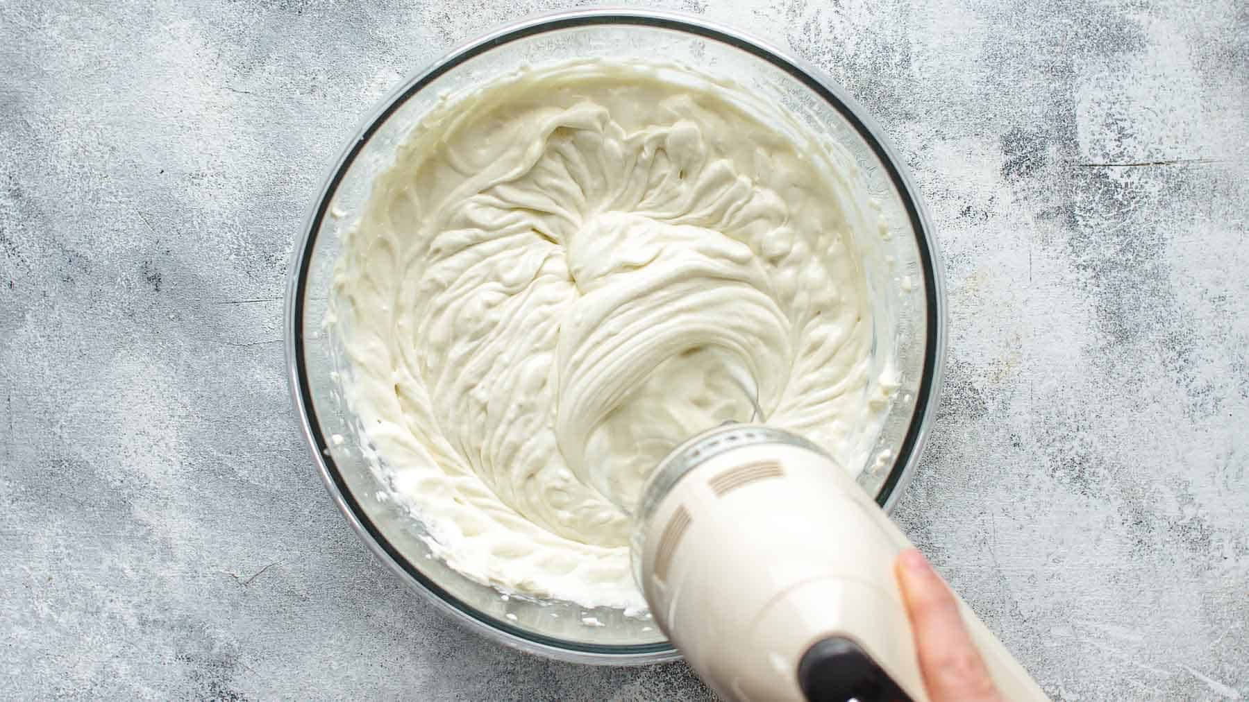 mixing cream cheese filling with mixer