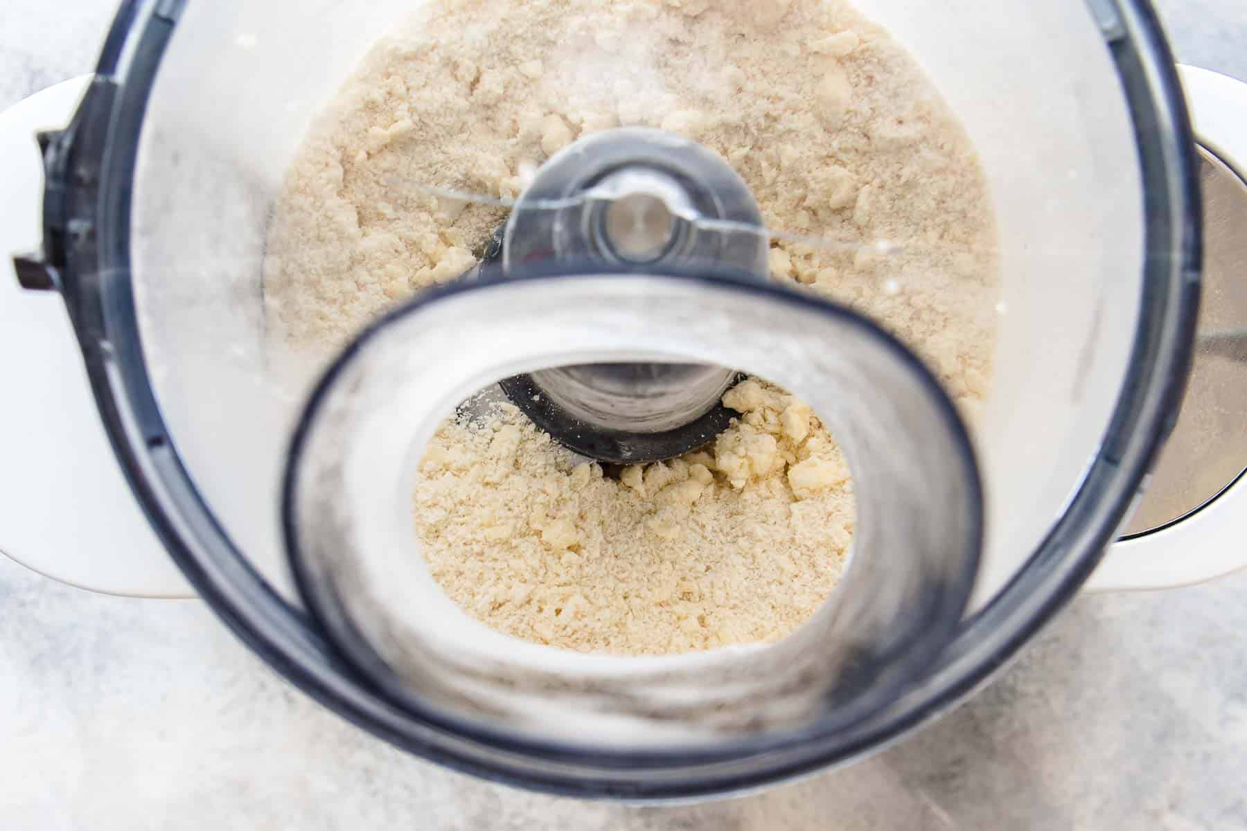 flour, sugar, salt, and butter processed to fine crumbs in a food processor