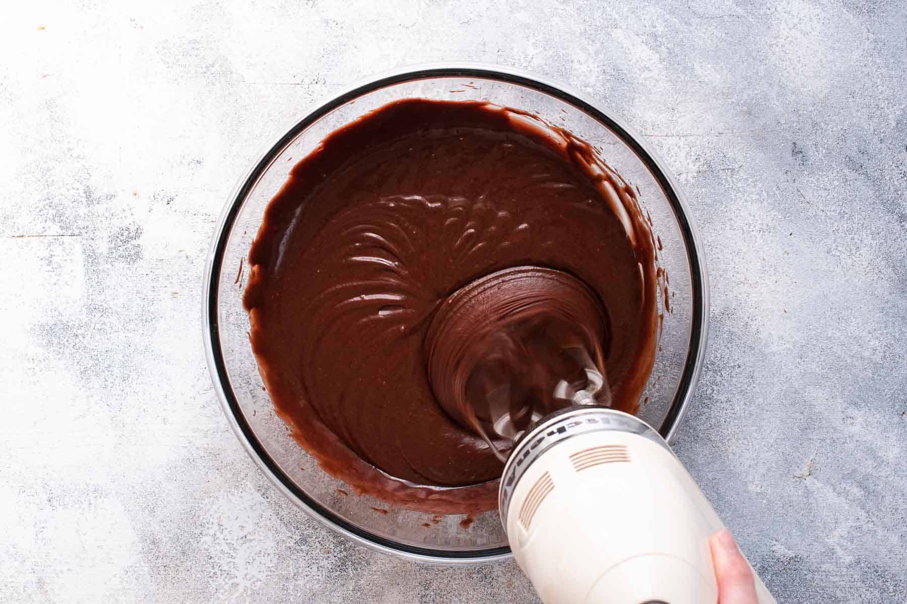 mixing thick chocolate cake batter with mixer
