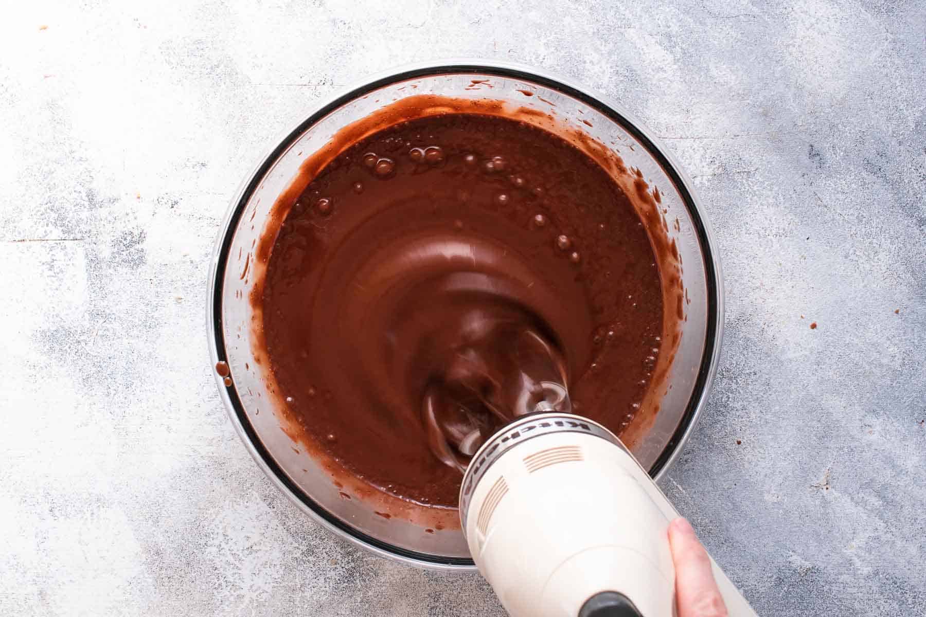 mixing water into chocolate cake batter with mixer