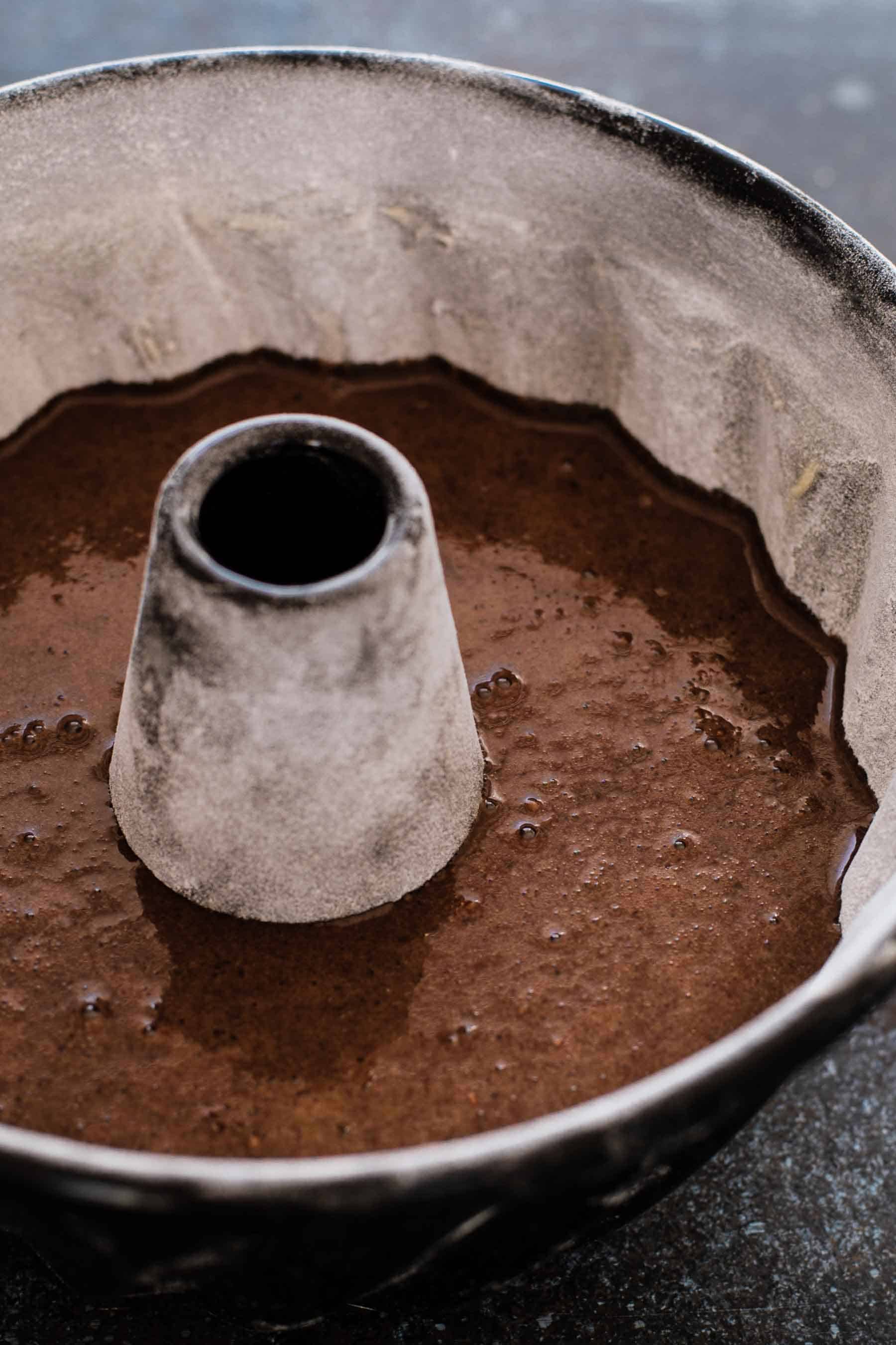 bundt pan half-filled with chocolate batter